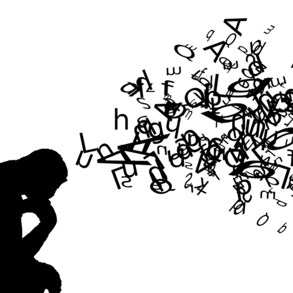 silhouette of a person thinking with a cloud of letters and symbols above them